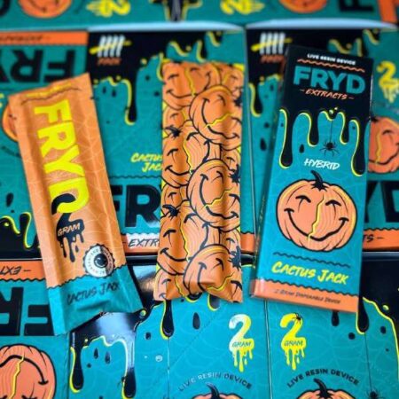 A Cactus Jack Fryd Extract disposable vape device held in hand, showcasing its blue and yellow packaging.