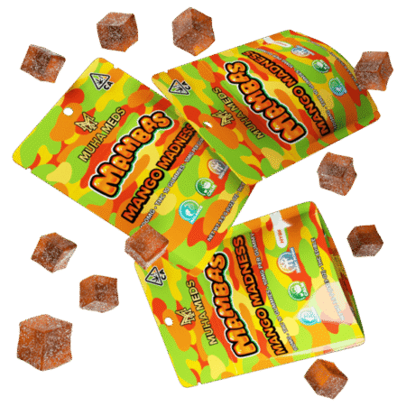 A package of Mango Madness Muha Meds Mambas gummies laid out, showcasing their vibrant color and texture.