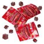 A package of Strawberry Muha Meds Mambas edibles laid out, showcasing the vibrant strawberry-colored candies.